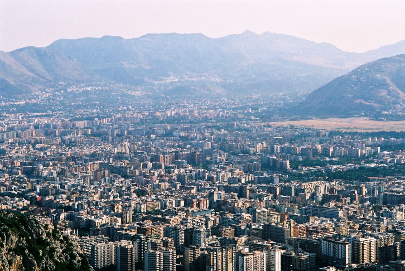 Edifici residenziali di Palermo visti dall’alto di Monte Pellegrino, con le montagne sullo sfondo